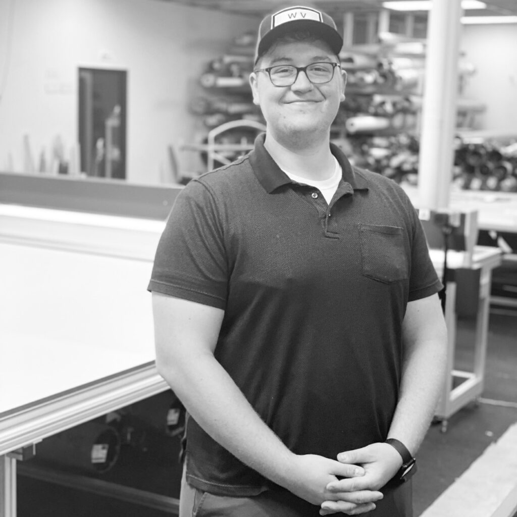 A man standing in front of a table.