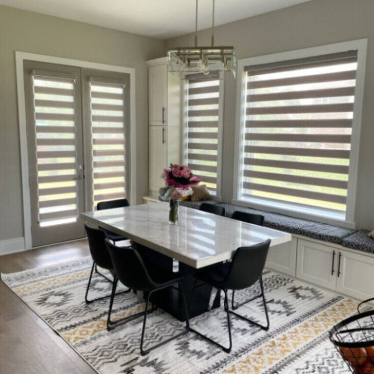 A dining room table with chairs and a window.