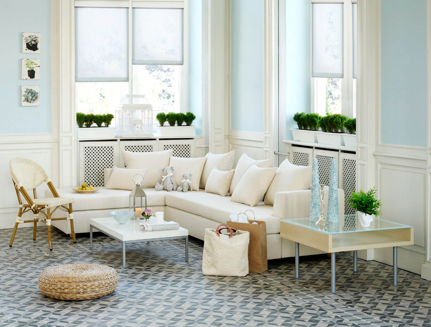 A living room with white furniture and blue walls