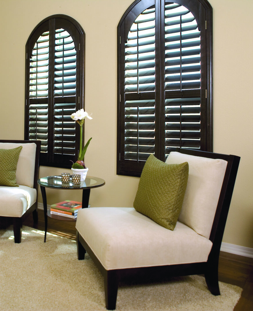 A living room with two chairs and tables