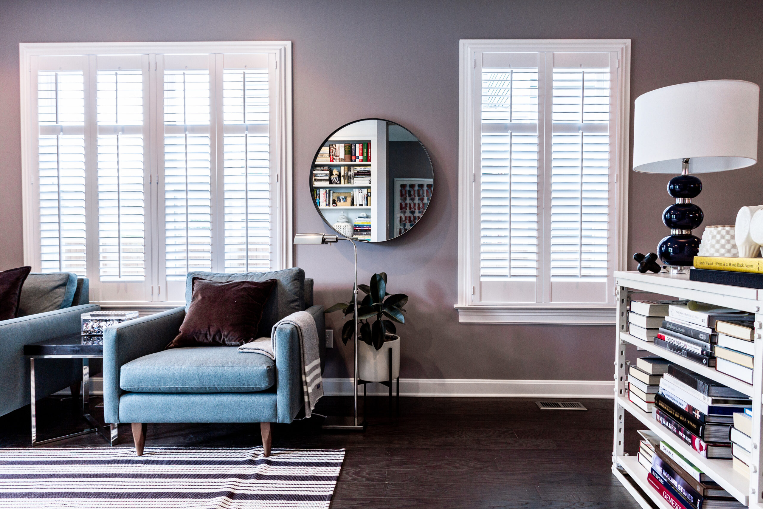 A living room with a couch and mirror