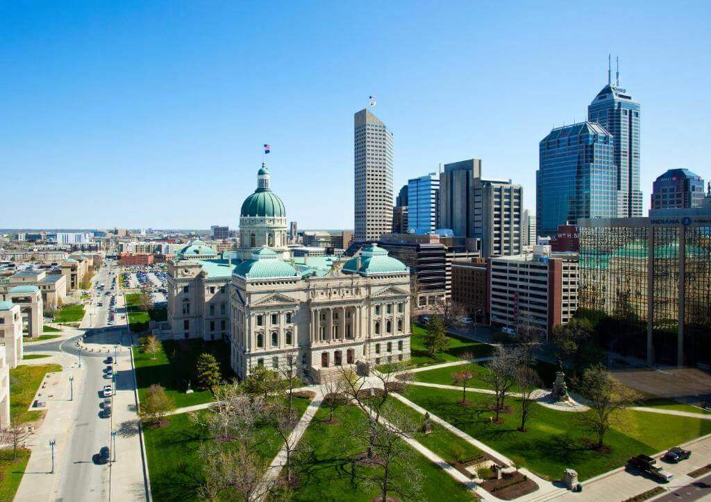 A view of the city from above shows a large park and buildings.