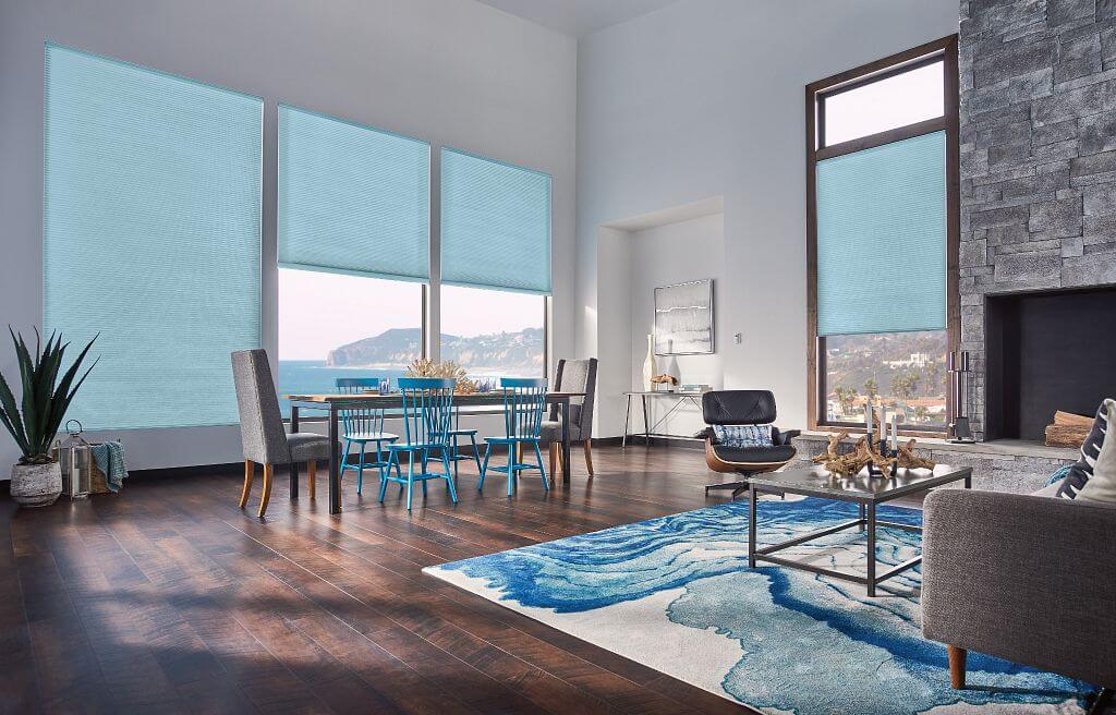 A living room with blue chairs and tables