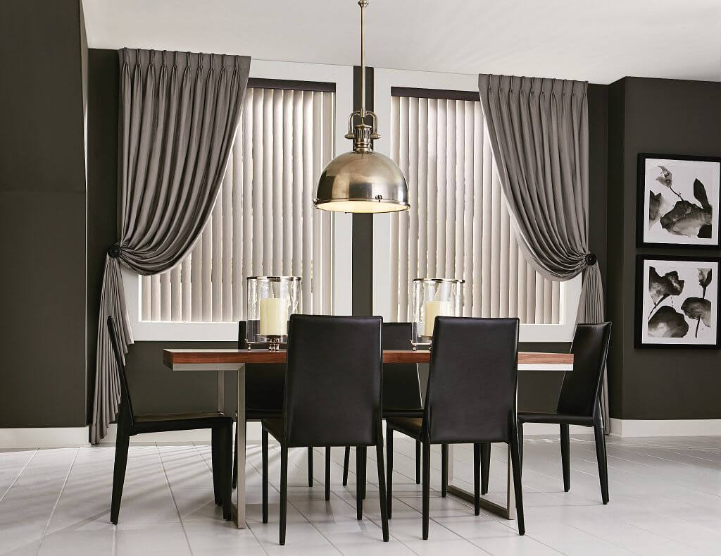 A dining room table with chairs and a lamp