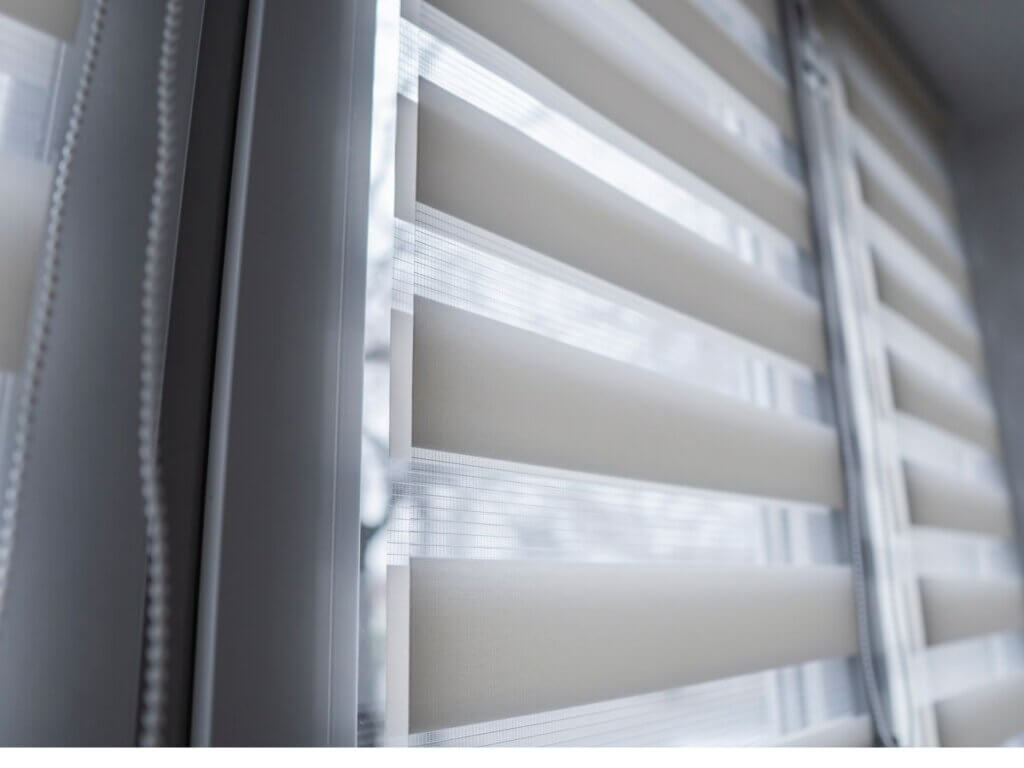 A window with blinds that are closed and open.