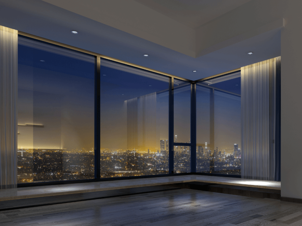 A room with large windows and a city view.