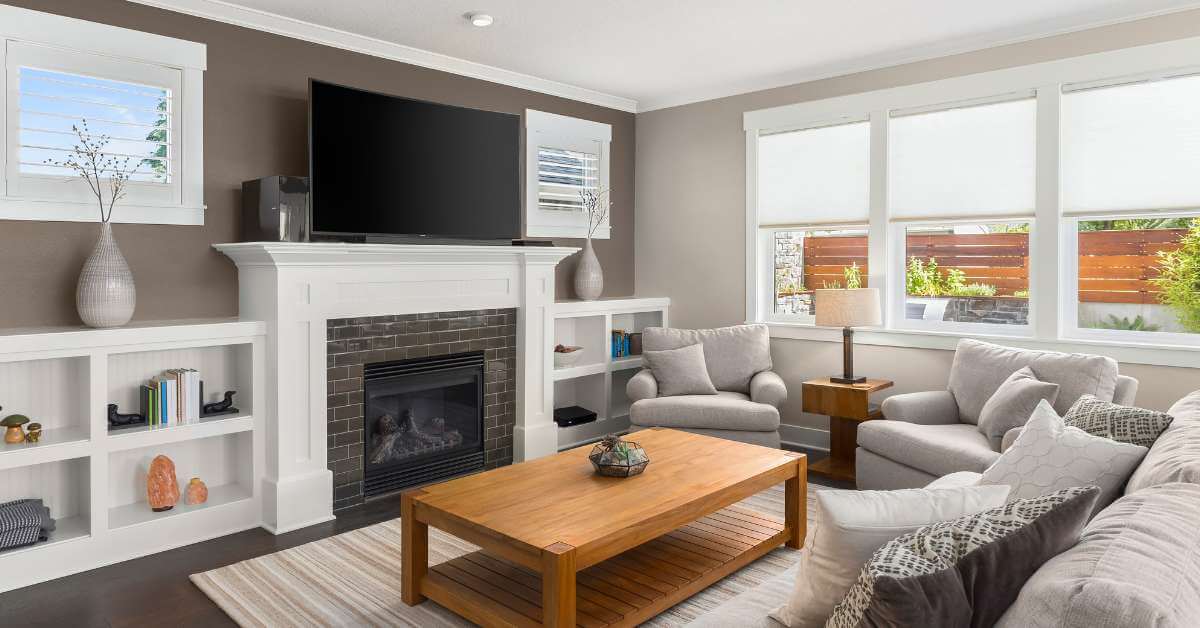 A living room with a fireplace and a flat screen tv.