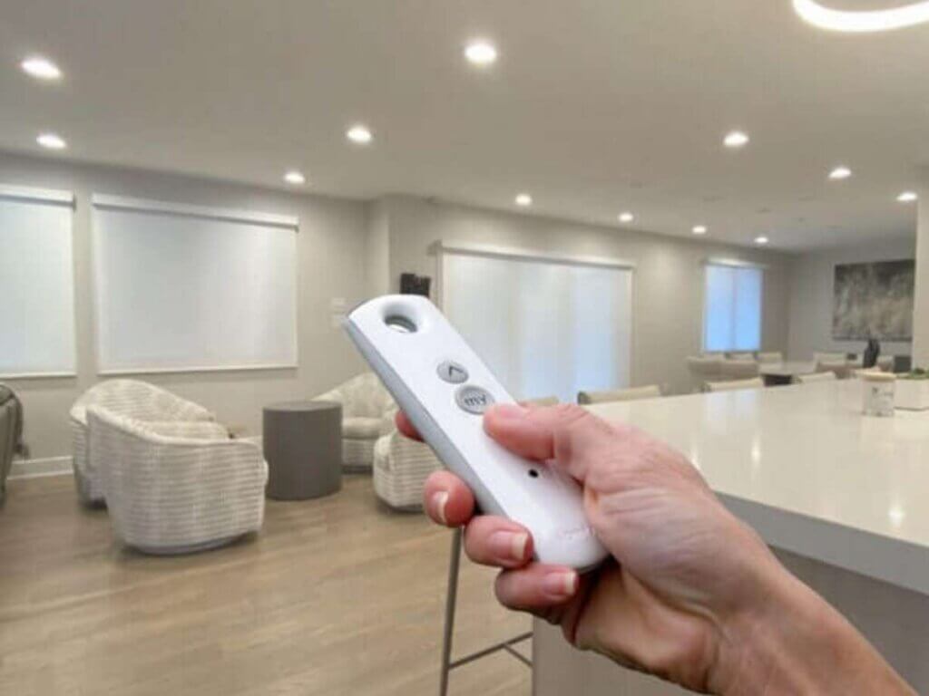 A person holding a remote control in their hand.