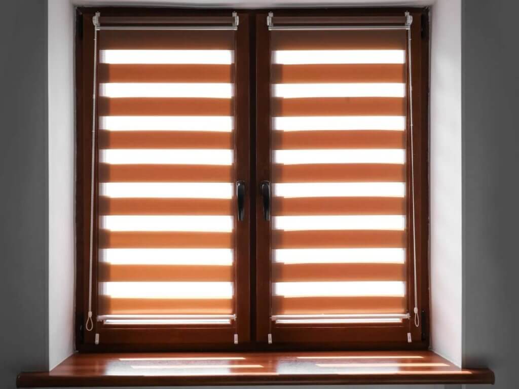 A window with two blinds opened and closed.