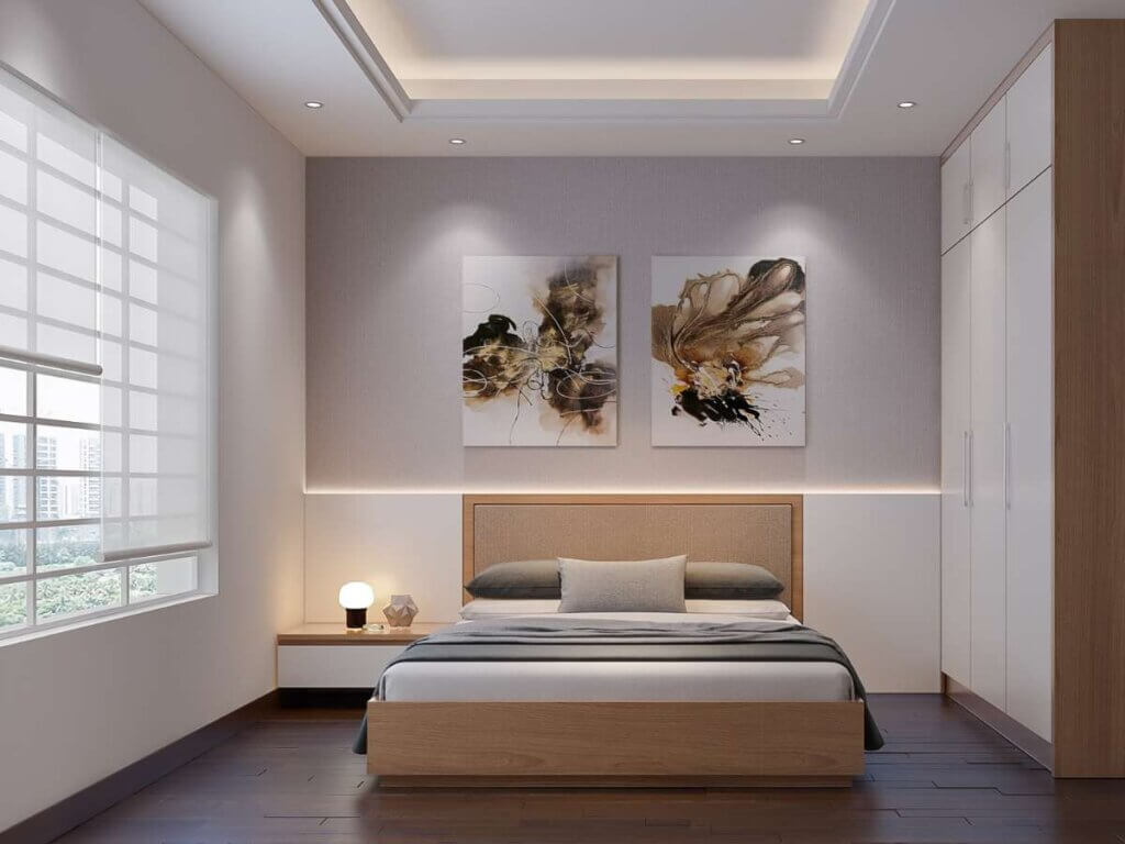 A bedroom with two paintings on the wall