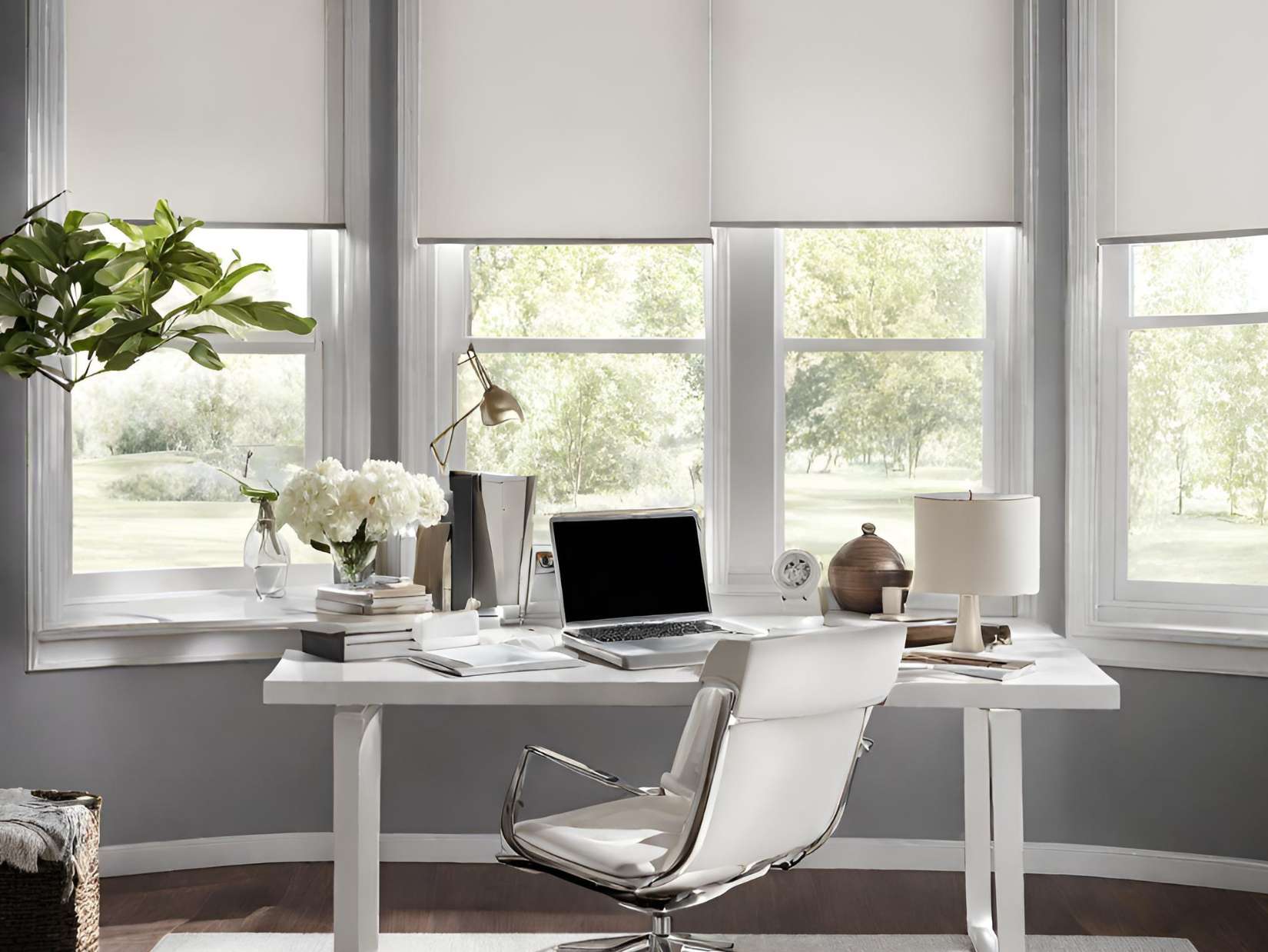 A white desk with a laptop and chair in front of a window.